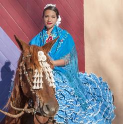 Alexina Garca Chvez rides side saddle on top of Poesa in the manner of the feria de abril (April Fair). 