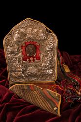 Gau (portable altar or amulet box), tsa tsa (votive offering with sacred image) featuring Avolokiteshevara, wood block printed prayer flags, and carrying case