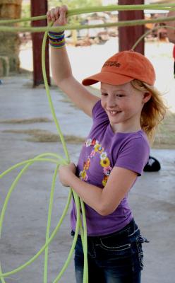 NMFRHM-A future cowgirl practices her roping skills at one of the New Mexico Farm & Ranch Heritage Museum’s summer camps
