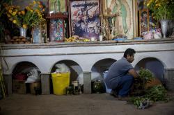 A man from Teotitln del Valle preparing the Day of the Dead altar in his home in Teotitln del Valle
