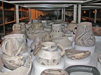 : 800 year old, pre-contact bowls and jars from the Museum of Indian Arts & Culture collections, densely packed onto shelves in their current storage room.  Photo by: Julia Clifton. Courtesy of the Museum of Indian Arts & Culture