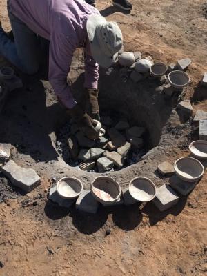11-LOA-2018 Office of Archaeological Studies Director Eric Blinman removes recently fired ceramics during a presentation of ceramic production. Photographer: Amy Montoya, Photo Courtesy of Museum of Indian Arts & Culture