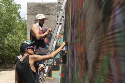 2-MOIFA-Gallery of Conscience Fernando Castro of Amapolay and Juan Lira painting at artist collective Alas de Aguas mural site in Santa Fe, June 27th, 2018  Photographer: Chloe Accardi 