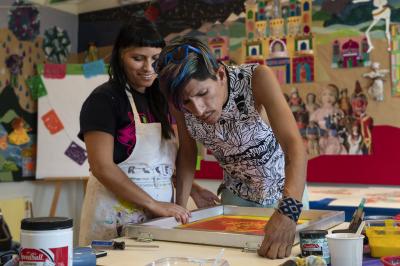 2-MOIFA-Gallery of Conscience :  : Carol Fernandez and Fernando Castro of Amapolay  painting at artist collective Alas de Aguas mural site in Santa Fe, June 27th, 2018   Photographer: Chloe Accardi   