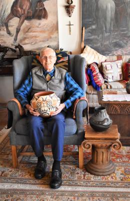 J. Paul Taylor with two of his pottery pieces